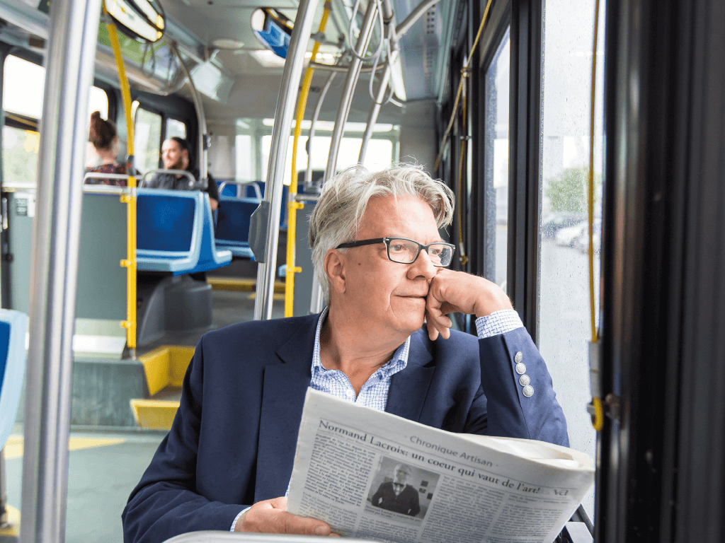 Représentation d'un client d'un certain âge dans l'autobus avec un journal à la main